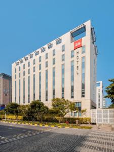 a large white building with a sign on it at ibis New Delhi Aerocity - An Accor Brand in New Delhi