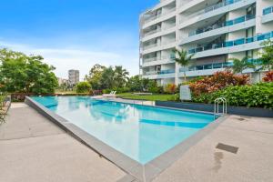 a swimming pool in front of a building at Experience Brisbane in Style Spacious 3 BR Retreat with Parking in West End in Brisbane