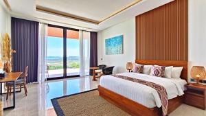 a bedroom with a large bed and a dining room at VILLA VALITO in Kuta Lombok +85 photos