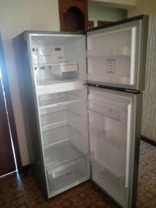 an empty refrigerator with its door open in a kitchen at casa de 2 pisos amplia y bonita in Oaxaca City
