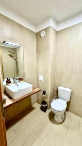 a bathroom with a white toilet and a sink at Boutique House Blue Lagoon by Flat Mаnаger in Balchik