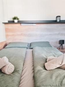 a bed with two pillows and two towels on it at Mobile homes Laguna, beach Porat, Drage in Drage +24 photos