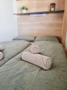 a pair of towels sitting on a bed at Mobile homes Laguna, beach Porat, Drage in Drage