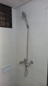 a shower with a shower head in a bathroom at Seaput Srisayang in Batu Ferringhi