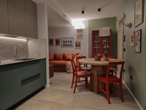 a kitchen with a table and a couch at Bolghera House in Trento