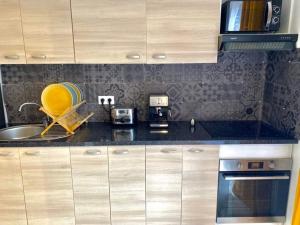 a kitchen with a sink and a microwave at Toulouse in Toulouse