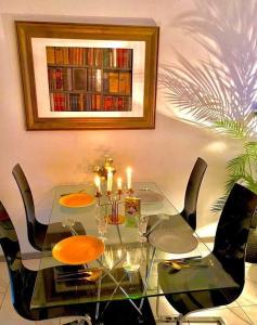 a glass dining room table with chairs and candles at Toulouse in Toulouse