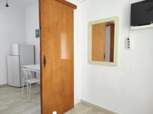 a room with a door and a mirror on a wall at Νέος Πύργος Studio in Neos Pirgos
