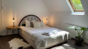 a bedroom with a large bed with towels on it at Cottage by the river Valea Draganului in Poeni
