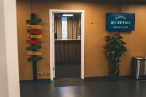 a door in a room with signs on the wall at Danhostel Aarhus City in Aarhus