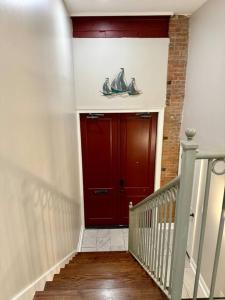 a stairway with a red door and a red wall at A Gem on the Strand in Galveston
