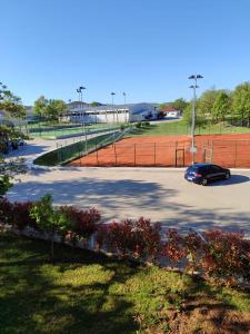 a car parked in a parking lot with a tennis court at Dea sobe in Posušje