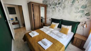 a bedroom with a large bed with two pillows on it at Apartament Garncarska in Elblag