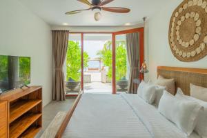 a bedroom with a bed and a ceiling fan at Veli Vilaa Dhiffushi - Beachfront in Dhiffushi