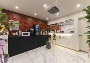 a restaurant with a counter with a microwave at Carlton Hotel Bupyeong in Incheon