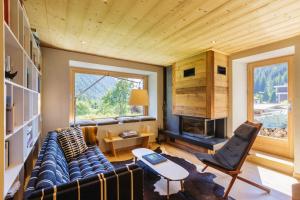 a living room with a couch and a fireplace at Chalet Plein Centre - Savoyard Moderne - Happy Rentals in Chamonix