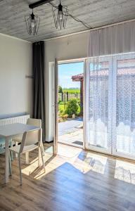 a dining room with a table and a sliding glass door at ISLAND4U in Gdańsk