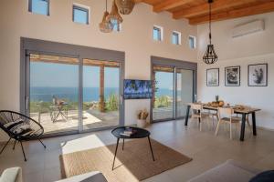 a living room with a view of the ocean at Villa Thea in Mochlos
