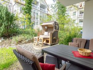 a patio with a table and chairs and a building at Residenz Margarete - Apt. 1.3 in Binz