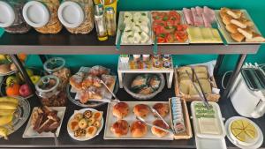 a table filled with lots of different types of food at Location10 in Palermo