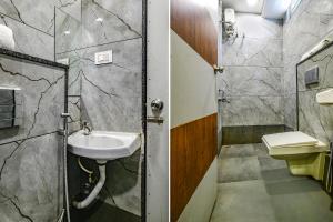 a bathroom with a sink and a shower at FabHotel SS Blue in Indore