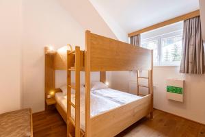 Łóżko lub łóżka w pokoju w obiekcie Almresort Gartnerkofel Nassfeld