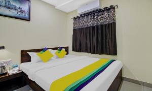 a bedroom with a bed and a window at Hotel Park Central in Kolkata
