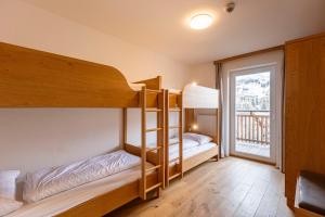 Łóżko lub łóżka w pokoju w obiekcie Almresort Gartnerkofel Nassfeld