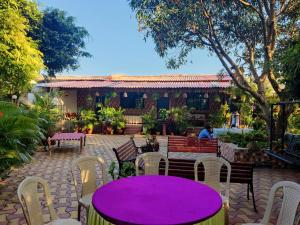 un tavolo viola e sedie di fronte a un edificio di Mahuli Agro Tourism a Mansar