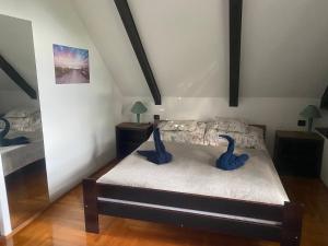 a bedroom with a bed with blue swans on it at Echo Apartman in Tihany
