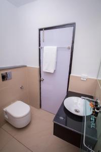 a bathroom with a toilet and a sink at TANTRA BOUTIQUE HOTEL in Imphal