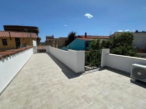 a view of a patio with a white fence at Casa Locci in San Vito