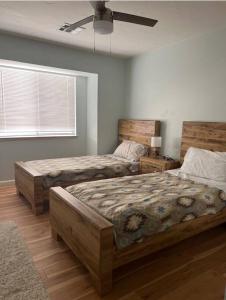 a bedroom with two beds and a window at Spacious house with pool at Mission Lake in Desert Hot Springs +30 photos