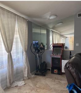 a living room with a treadmill and a window at Spacious house with pool at Mission Lake in Desert Hot Springs
