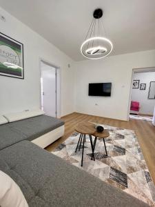a living room with a couch and a table at R&D Central Apartment in Prilep