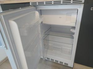 an empty refrigerator with its door open in a kitchen at Schlafende Hexe in Bischofswiesen