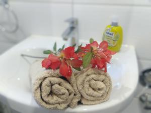 a vase with flowers on top of a toilet at Schlafende Hexe in Bischofswiesen +18 photos