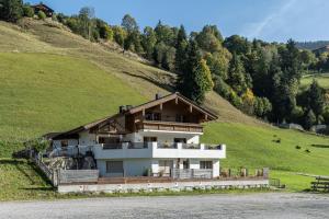 a house on the side of a hill at Hochwart Apartment - Familienapartments in Saalbach Hinterglemm