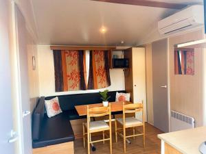 a small dining room with a table and chairs at Camping Europcamping in Fréjus +6 photos
