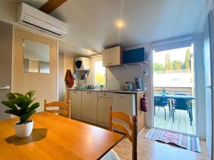 a kitchen and dining room with a table and a dining room at Camping Europcamping in Fréjus