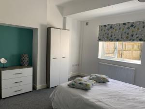 a bedroom with a bed with two pillows on it at Cleadon in Goole