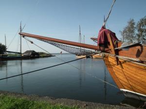 a wooden boat tied up in the water at Haus Jasmin in Bodstedt