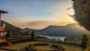 a garden with a view of a body of water at Sundew-n-Lake in Nainital