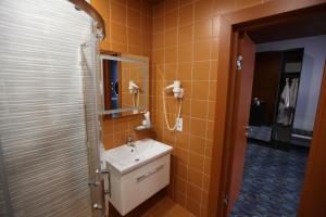a bathroom with a sink and a mirror at LOMO Hotel Uman in Umanʼ