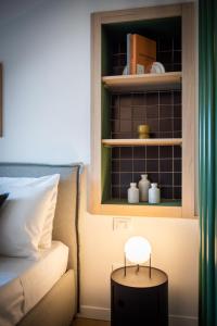 a room with a bed and a stool next to a bed at Turin Sky House City Center in Turin