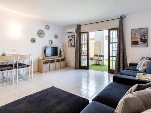 a living room with a couch and a tv at Port Royale 291, Spacious Studio in Los Cristianos