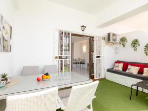 a living room with a table and chairs and a couch at Port Royale 291, Spacious Studio in Los Cristianos