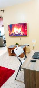 an office with a chair in front of a fireplace at 2 Bedroom at Kamakis near Greenspot Long term 5 days plus in Ruiru