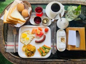 a plate of breakfast food on a table at Eco Resort in Dhulikhel