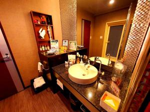 a bathroom with a sink and a mirror at Hotel Vanilla Komaki (Adult Only) in Komaki